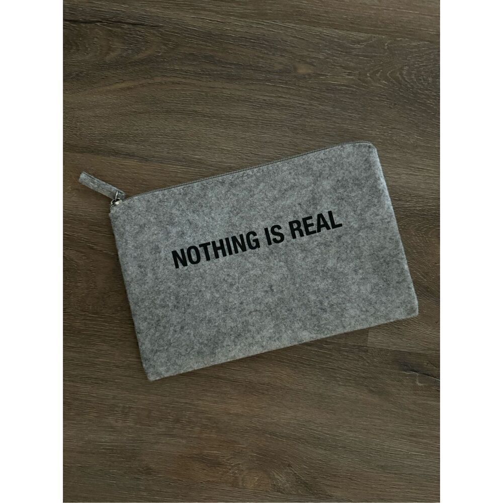 Slnghr Zip Clutch Bag Nothing Is Real